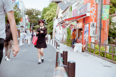 Woman standing in front of building