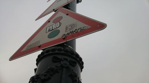 Low angle view of road sign against sky