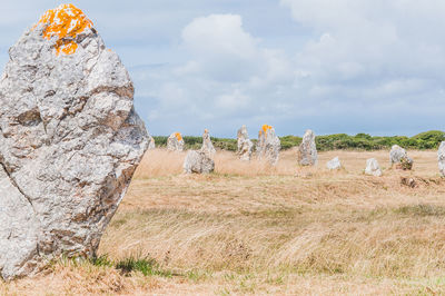 Panoramic view of rocks on field against sky