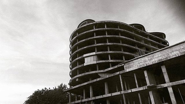 architecture, low angle view, built structure, building exterior, sky, modern, building, tall - high, tower, office building, city, skyscraper, day, outdoors, window, glass - material, no people, tall, architectural feature, cloud - sky