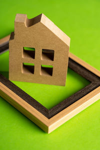 High angle view of stuffed toy against green background