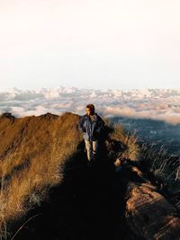 Rear view of man walking on mountain