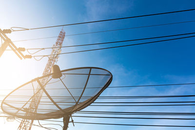 Low angle view of electricity pylon against sky