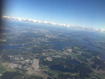 Scenic view of landscape and sea against river against sky seen from airplane window