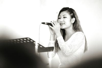 Woman singing on stage in ceremony