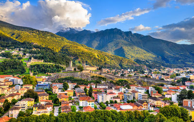 Panoramic view of townscape and mountains against sky