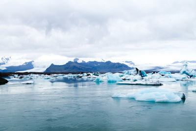 Scenic view of frozen lake against sky