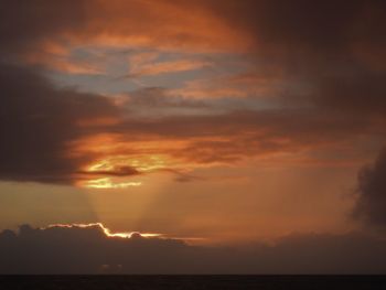 Scenic view of dramatic sky over sea during sunset