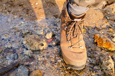 Low section of person standing in mud