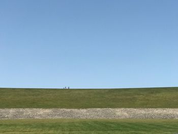 Scenic view of field against clear blue sky