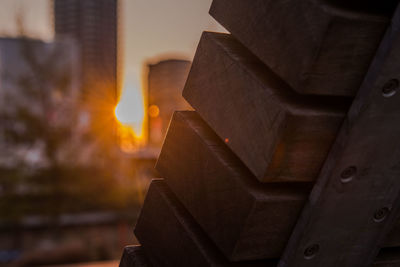Close-up of stack of wood against sky during sunset