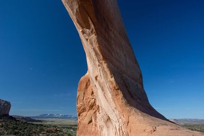 Low angle view of rock formation against blue sky at arches national park