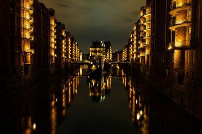 Reflection of illuminated buildings in canal at night