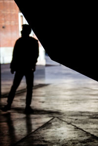 Rear view of silhouette men walking in city