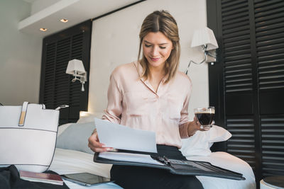 Young woman using mobile phone in office