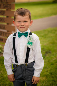 Portrait of smiling boy standing on field