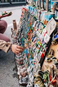 Midsection of woman buying souvenirs