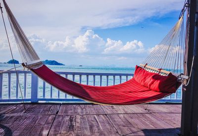 Side view of hammock against calm sea