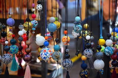 Close-up of decorations hanging in store for sale