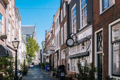 Street amidst buildings against sky in city