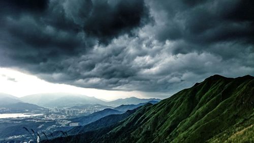 Scenic view of mountains against cloudy sky