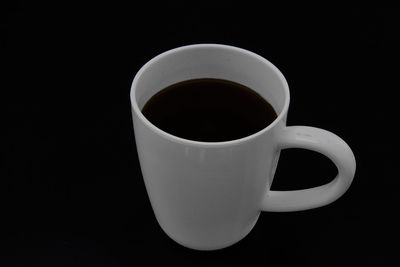 High angle view of coffee cup against black background