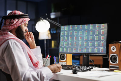 Midsection of businessman working at office