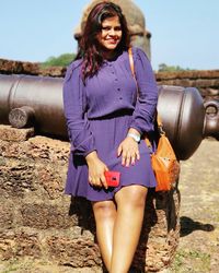 Portrait of young woman standing outdoors