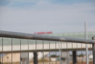 Close-up of railing against sky