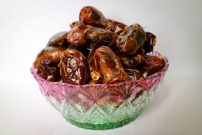 Close-up of glass on table against white background