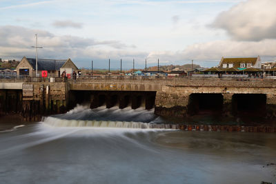 Long exposure of the river flowing into the harbour at west bay in dorset 
