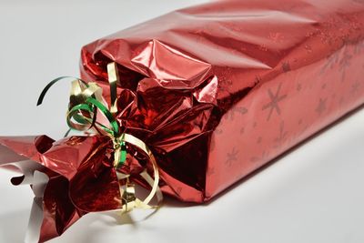 Close-up of red wrapped in box on table