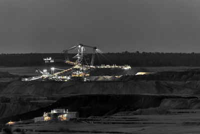 Illuminated commercial dock against clear sky at night