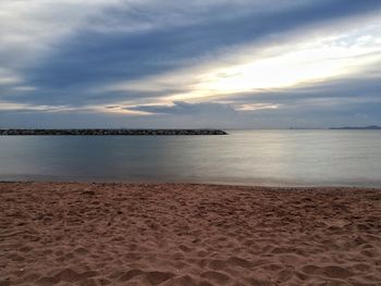 Scenic view of beach against sky during sunset