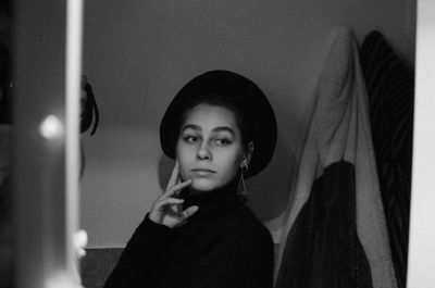 Young woman reflecting on mirror at home