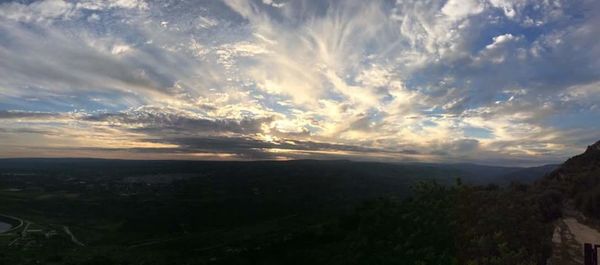 Scenic view of mountains against cloudy sky