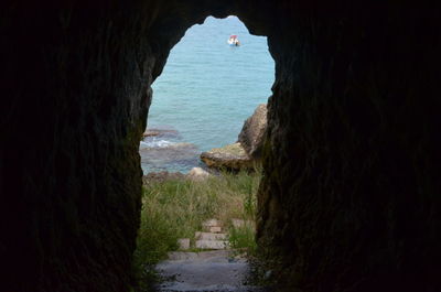 Scenic view of sea seen through rocks