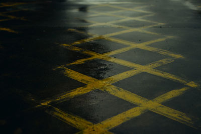 High angle view of yellow umbrella on wet road