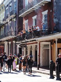 People walking on street against buildings in city