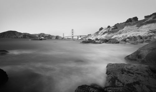 Scenic view of bay against clear sky