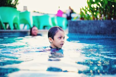 Portrait of boy swimming in pool