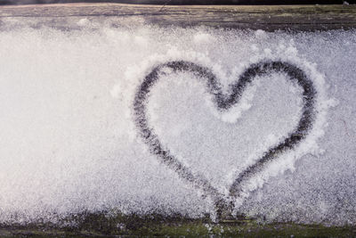 Close-up of heart shape on snow