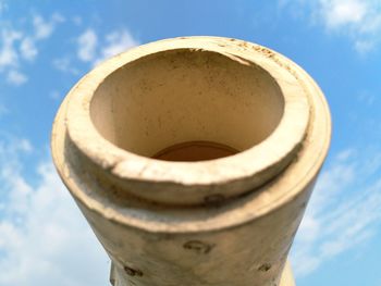Low angle view of rusty metal against sky