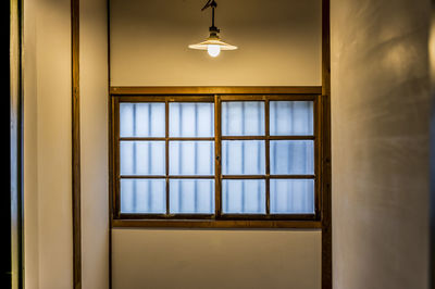 Low angle view of illuminated pendant lights hanging from ceiling