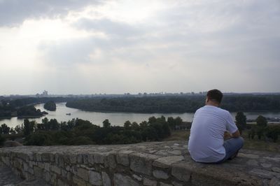 Rear view of man looking at sea