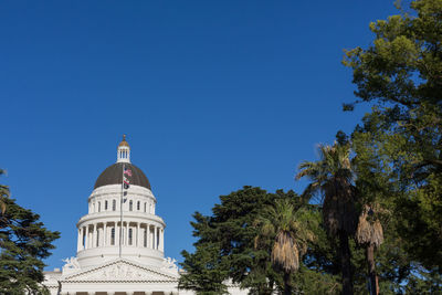 Low angle view of building against clear blue sky