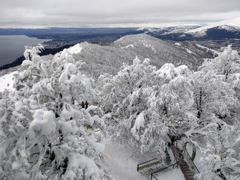 Aerial view of snow covered mountains against sky