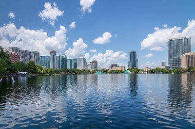 City by river against sky