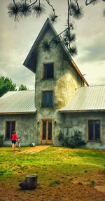 Houses against cloudy sky