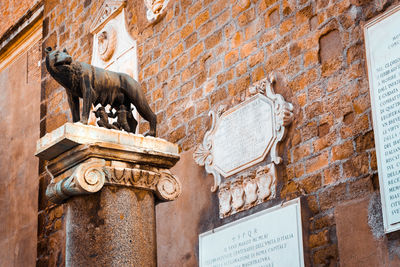 Low angle view of statues on wall